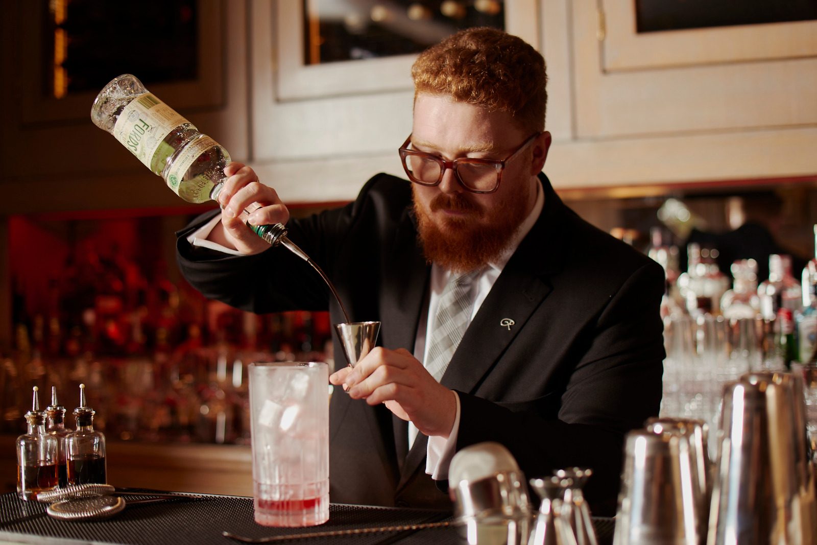 Samuel Slaughter pouring through a jigger at the bar